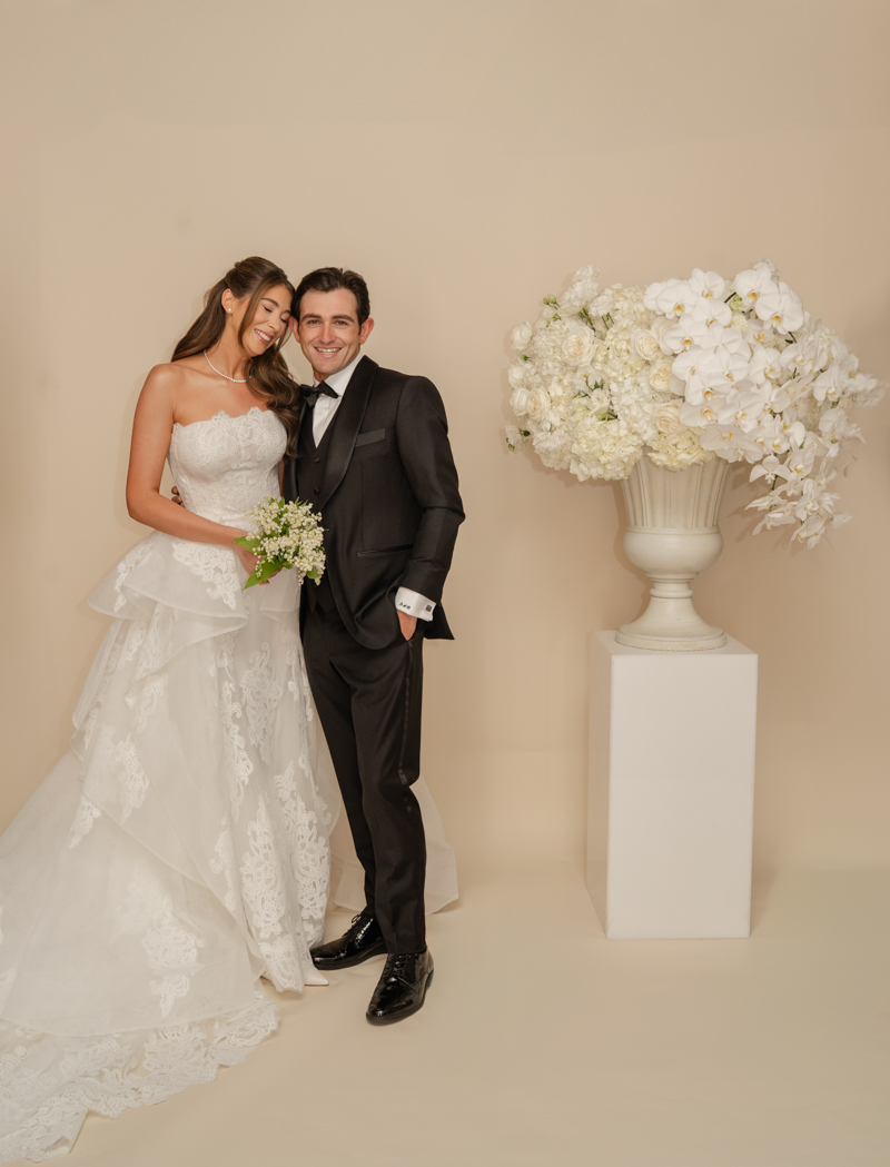 bride and groom editorial photos with floral piece