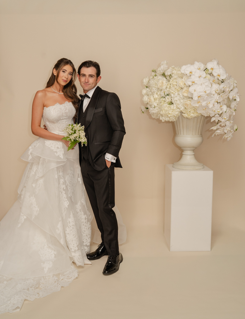 bride and groom editorial photos with floral piece