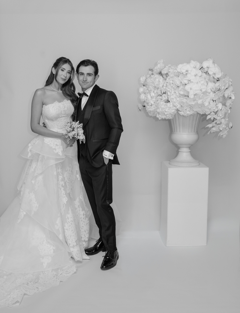 bride and groom editorial photos with floral piece