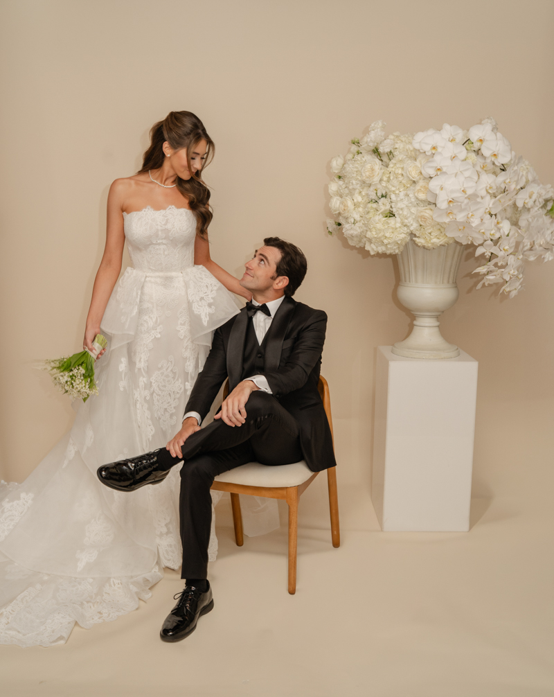 bride and groom editorial photos with floral piece