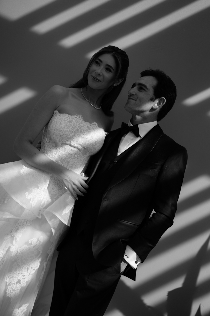 bride and groom editorial photos with floral piece